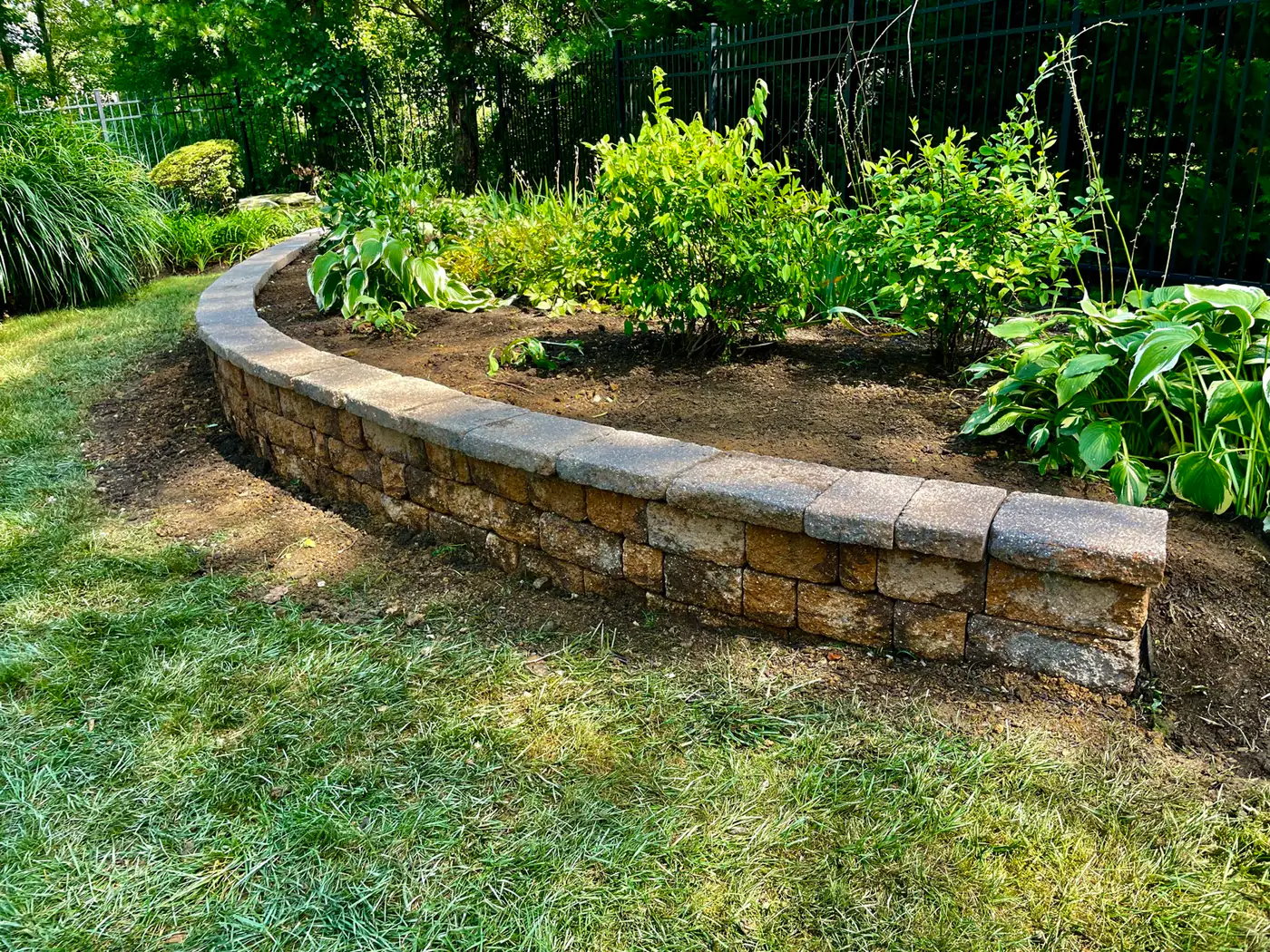 Curved block retaining wall with steps built by Mex Landscaping